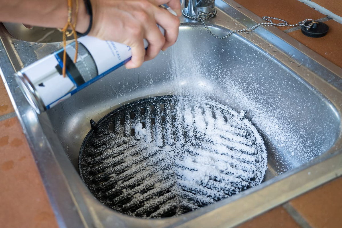 Spraying CADAC grill cleaner spray for stubborn stains